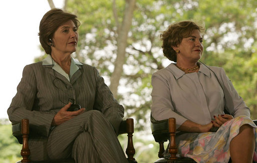 Mrs. Laura Bush and Mrs. Marisa Leticia da Silva listen to remarks by their husbands, during a joint statement at Granja do Torto, home of Brazil President Luiz Inacio Lula da Silva, Saturday, Nov. 6, 2005. White House photo by Paul Morse