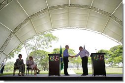 President George W. Bush and Brazil President Luiz Inacio Lula da Silva exchange handshakes Saturday, Nov. 6, 2005, after they delivered joint statements at the Brazil President's home, Granja do Torto. White House photo by Paul Morse