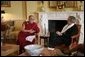 President George W. Bush, wearing a scarf presented to him by the Dalai Lama, meets with the Buddhist spiritual leader Wednesday, Nov. 9, 2005, in the private residence of the White House. White House photo by Paul Morse