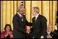 President George W. Bush presents the Presidential Medal of Freedom to baseball legend Frank Robinson in the East Room Wednesday, Nov. 9, 2005. Winning the Most Valuable Player awards in the National and American Leagues, he achieved the American League Triple Crown in 1966. Mr. Robinson became baseball's first African-American manager. White House photo by Paul Morse