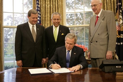 President George W. Bush is backed by U.S. Rep. Tom Latham, R-Iowa, left, U.S. Rep. Henry Bonilla, R-Texas, center, and U.S. Sen. Robert Bennett, R-Utah, Thursday, Nov. 10, 2005 in the Oval Office, as he signs H.R. 2744-Agriculture, Rural Development, Food and Drug Administration, and Related Agencies Appropriations Act, 2006. White House photo by Eric Draper