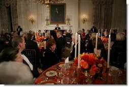 President George W. Bush welcomes guests in the State Dining Room of the White House, Thursday, Nov. 10, 2005, at the dinner celebrating the 40th Anniversary of the National Endowment for the Arts and the National Endowment for the Humanities.  White House photo by Paul Morse