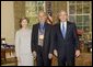 President George W. Bush and Laura Bush stand with author Louis Auchincloss, recipient of the 2005 National Medal of Arts, in the Oval Office Thursday, Nov. 10, 2005. White House photo by Eric Draper