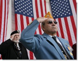 Veterans Jose Garcia, right, and John Rowan, salute Friday, Nov. 11, 2005, during Veterans Day ceremonies at Arlington National Cemetery in Arlington, Va. White House photo by David Bohrer