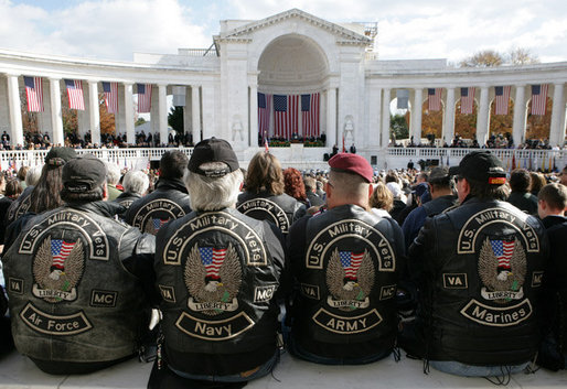 A group of men wearing vests honoring the various branches of the Armed Forces, attend ceremonies Friday, Nov. 11, 2005, during Veterans Day events at Arlington National Cemetery in Arlington, Va. White House photo by David Bohrer