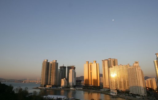 The moon sits over the Gwangan Grand Bridge and the city of Busan, Korea, sight of the 2005 APEC summit. White House photo by Shealah Craighead