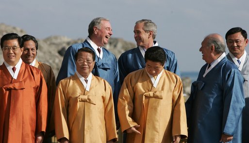 President Bush and Canada's Prime Minister Paul Joseph Martin break out in laughter Saturday, Nov. 19, 2005, as they stand in on the back riser for the official APEC photograph. White House photo by Paul Morse