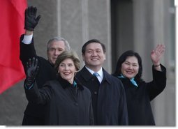 President Bush and Laura Bush join Mongolia President Nambaryn Enkhbayar and his wife, Onongiin Tsolmon, as they wave to spectators Monday, Nov. 21, 2005, during welcoming ceremonies for the Bushes in Ulaanbaatar, Mongolia.  White House photo by Paul Morse