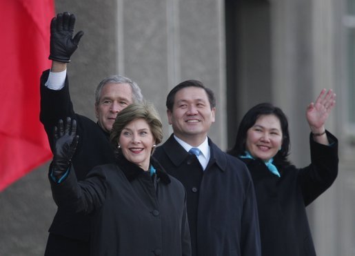 President Bush and Laura Bush join Mongolia President Nambaryn Enkhbayar and his wife, Onongiin Tsolmon, as they wave to spectators Monday, Nov. 21, 2005, during welcoming ceremonies for the Bushes in Ulaanbaatar, Mongolia. White House photo by Paul Morse