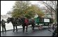 A U.S. Park Service officer helps guide a horse drawn carriage delivering the official White House Christmas tree, Monday, Nov. 28, 2005. This year's tree, donated by the Deal Family of Smokey Holler Tree Farm in Laurel Springs, N.C., is the 40th year the National Christmas Tree Growers Association has provided a tree to the White House. White House photo by Shealah Craighead