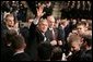 President Bush waves to the crowd after delivering an emphatic statement on the War on Terror Wednesday, Nov. 30, 2005, at the U.S. Naval Academy in Annapolis. "Victory in Iraq will demand the continued determination and resolve of the American people," said the President. White House photo by Paul Morse