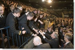 President George W. Bush reaches out to Midshipmen at the United States Naval Academy Wednesday, Nov. 30, 2005, in Annapolis, Maryland, where he spoke on the War on Terror. The President thanked the Midshipmen for volunteering to serve and told them America is grateful for their devotion to duty.  White House photo by Paul Morse