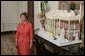 Laura Bush stands before the White House gingerbread house , Wednesday, Nov. 30, 2005, as she answers questions during the press preview of the White House Christmas decorations. White House photo by Shealah Craighead