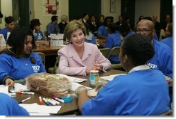 Laura Bush talks with students Wednesday, Nov. 30, 2005 during a visit to the Church of the Epiphany in Washington, as part of her Helping America's Youth initiative, where the students, part of the Youth Service Learning Project, were preparing sandwiches to feed the homeless.  White House photo by Shealah Craighead