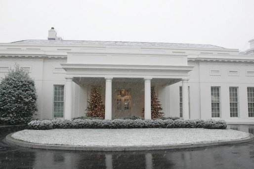 The glow of Christmas Trees guides the way to the West Wing Lobby during the season's first snow fall Monday, Dec. 5, 2005. White House photo by Shealah Craighead