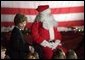 Laura Bush talks with a group of children as she visits the Naval and Marine Corps Reserve Center in Gulfport, Miss., Monday, Dec. 12, 2005, where she showed them a White House holiday video, 'A Very Beazley Christmas' featuring the Bush's dogs, Barney and Miss Beazley. White House photo by Shealah Craighead