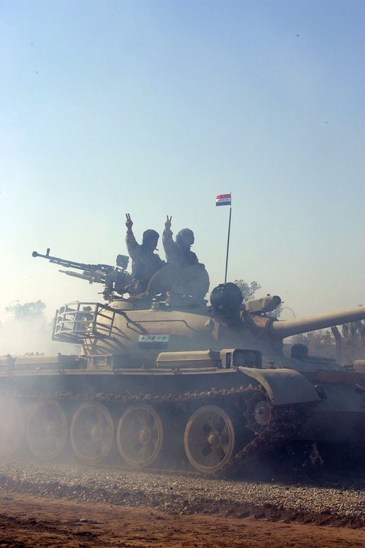 Vice President Dick Cheney visits the 9th Mechanized Infantry Division Headquarters at Taji Air Base to greet Iraqi troops and view tanks and armored vehicles they have refurbished into working fighting vehicles, Sunday Dec. 18, 2005. White House photo by David Bohrer