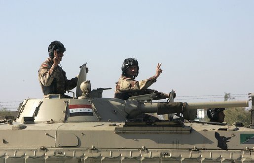 Vice President Dick Cheney visits the 9th Mechanized Infantry Division Headquarters at Taji Air Base to greet Iraqi troops and view tanks and armored vehicles they have refurbished into working fighting vehicles, Sunday Dec. 18, 2005. White House photo by David Bohrer