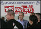 President George W. Bush meets with U.S. Marines working Monday, Dec. 19, 2005 at the "Toys for Tots" collection center at the Naval District Washington Anacostia Annex in Washington, D.C. White House photo by Kimberlee Hewitt