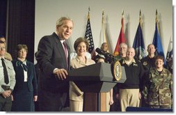 With Mrs. Laura Bush looking on, President George W. Bush addresses military medical caregivers Wednesday, Dec. 21, 2005, before visiting with the wounded at the National Naval Medical Center in Bethesda, Md. The President told the caregivers, ". On behalf of a grateful nation, thanks for doing your duty, thanks for serving, thanks for being an important part of this march for freedom; and thanks, most of all, for bringing comfort and aid and solace to those who have been hurt on the battlefield and their families." White House photo by Paul Morse