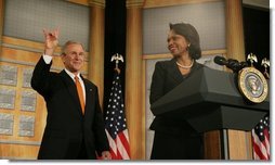 President George W. Bush returns the "Hook'em Horns" hand gesture back to audience members, Thursday, Jan. 5, 2006, as he is being introduced by U.S. Secretary of State Condoleezza Rice at the State Department, prior to his remarks to the U.S. University Presidents Summit on International Education. The gesture was in recognition of the University of Texas football team's victory over the University of Southern California in the Rose Bowl, Wednesday evening.  White House photo by Kimberlee Hewitt