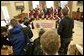 President George W. Bush stands with the 2005 Little League Softball World Series Champions in the Oval Office Tuesday, Jan. 10, 2006. The McLean, Va., All-Star team represented the South Region and bested six regional championship teams during a week-long tournament in Portland, Ore. White House photo by Eric Draper