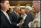 After talking about progress in the War on Terror with members of the Veterans of Foreign War, President George W. Bush greets audience members in Washington, D.C., Jan. 10, 2006. "This is one of America's great organizations. I appreciate the proud and patriotic work you do across America," said the President. White House photo by Paul Morse