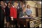 President George W. Bush signs H.R. 972, the Trafficking Victims Protection Reauthorization Act of 2005, in the Dwight D. Eisenhower Executive Office Building Tuesday, Jan. 10, 2006. The bill directs the U.S. Agency for International Development (USAID), the State Dept., and Dept. of Defense to incorporate anti-trafficking and protection measures for vulnerable populations, particularly women and children, into their post-conflict and humanitarian emergency assistance and program activities. White House photo by Eric Draper