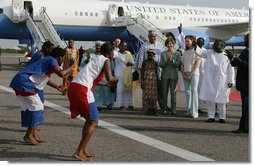 Mrs. Laura Bush and her daughter Barbara Bush are greeted by a cultural dance troupe upon their arrival Sunday, Jan. 15, 2006 at Kotoka International Airport in Accra, Ghana. White House photo by Shealah Craighead