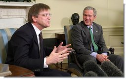 President George W. Bush breaks out in laughter as he listens to Belgian Prime Minister Guy Verhofstadt Tuesday, January 17, 2006, during the Prime Minister's visit to the Oval Office.  White House photo by Paul Morse