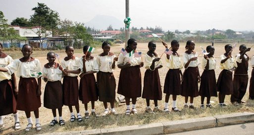 Students at Model Secondary School in Abuja, Nigeria, wave American flags as they line the street during a visit by Laura Bush Wednesday, Jan. 18, 2006. White House photo by Shealah Craighead