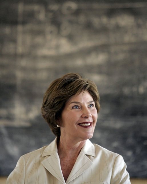 Mrs. Laura Bush smiles as she listens to a student at Model Secondary School Wednesday, Jan. 18, 2006, in Abuja, Nigeria. The visit came on the last of a four-day visit to West Africa. White House photo by Shealah Craighead