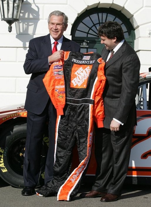 President George W. Bush is presented with his own racing suit by 2005 NASCAR Nextel Cup Champion Tony Stewart, Tuesday, Jan. 24, 2006 on the South Lawn at the White House. White House photo by Eric Draper