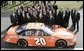 President George W. Bush poses with 2005 NASCAR Nextel Cup Champion team and their car, Tuesday, Jan. 24, 2006 on the South Lawn driveway at the White House. White House photo by Eric Draper