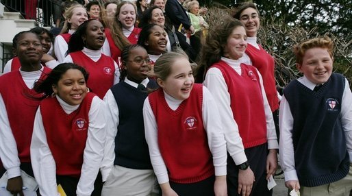 Youngsters from the Cathedral Church of St. John react as they watch the arrival of Marine One to the South Lawn of the White House with President George W. Bush aboard Wednesday, Jan. 25, 2006. White House photo by Paul Morse