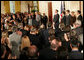 President George W. Bush welcomes an audience to the swearing-in ceremony for U.S. Supreme Court Justice Samuel A. Alito, Tuesday, Feb. 1, 2006 in the East Room of the White House, joined by Altio's wife, Martha-Ann, their son Phil, daughter, Laura, and U.S. Supreme Court Justice John Roberts. White House photo by Shealah Craighead