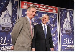 President George W. Bush stands with New Hampshire U.S. Senator Judd Gregg prior to addressing his remarks on the 2007 Budget and the Deficit Reduction Act of 2005, in a speech to the Business and Industry Association of New Hampshire, Wednesday, Feb. 8, 2006 in Manchester, N.H.  White House photo by Paul Morse