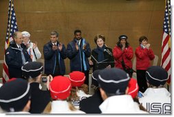 Mrs. Laura Bush, is joined by former Olympians, as she speaks to U.S. 2006 Winter Olympic athletes in Turin, Italy, Friday, Feb. 10, 2006, prior to the Winter Olympic opening ceremony.  