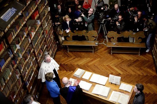 Laura Bush looks at an Ancient Thesis of Montichelli during a tour given by Enrico Artifoni, right, Paolo Novaria, right, and Andrea Carosso at the University of Turin Saturday, Feb. 11, 2006, in Turin, Italy. White House photo by Shealah Craighead