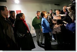 Laura Bush flanked by members of the U.S. Olympic Delegation, (from left) Roland Betts, Dr. Debi Thomas, Herschel Walker and Dr. Eric Heiden meet with members of the press after watching the Men’s U.S. Speed Skating competition at the 2006 Winter Olympics in Turin, Italy.  White House photo by Shealah Craighead