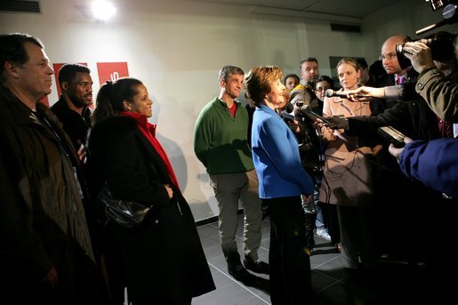 Laura Bush flanked by members of the U.S. Olympic Delegation, (from left) Roland Betts, Dr. Debi Thomas, Herschel Walker and Dr. Eric Heiden meet with members of the press after watching the Men’s U.S. Speed Skating competition at the 2006 Winter Olympics in Turin, Italy. White House photo by Shealah Craighead