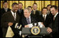 President George W. Bush is presented with a Chicago White Sox jacket and baseball jersey, Monday, Feb. 13, 2006 by White Sox players Jermaine Dye, left, and Paul Konerko in the East Room of the White House, where President Bush honored the 2005 World Series Champions. White House photo by Eric Draper