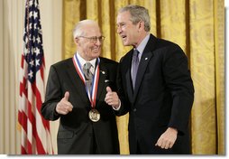 President George W. Bush presents a National Medal of Science, Monday, Feb. 13, 2006 to Dr.Norman E. Borlaug of Texas A&M University, during ceremonies in the East Room of the White House. Borlaug was honored for his work in creating disease resistant and high-yield wheat, providing a new quality food source for millions of people around the world. White House photo by Eric Draper