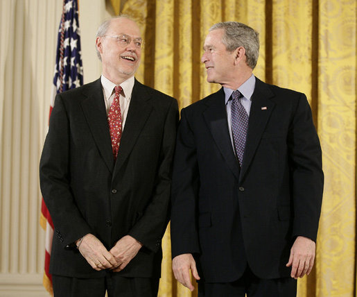 President George W. Bush speaks with Dr. Phillip A. Sharp of the Massachusetts Institute of Technology prior to being presented a National Medal of Science, Monday, Feb. 13, 2006 during ceremonies in the East Room of the White House. Dr. Sharp is honored for his contributions to the understanding of RNA interference techniques to perform genetic analyses in mammalian cells. White House photo by Eric Draper