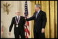 President George W. Bush presents a National Medal of Technology, Monday, Feb. 13, 2006 to Ralph H. Baer of Manchester, N.H., during ceremonies in the East Room of the White House. Baer was honored for his groundbreaking and pioneering creation, development and commercialization of interactive video games. White House photo by Eric Draper