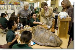 Laura Bush, listens to a student talk about Sea Turtles, Thursday, Feb. 16, 2006, as Fran Mainella, Director of the National Park Service, and Stella Summers, Teacher of the Gifted Science class, look on during a visit to Banyan Elementary School in Miami, FL, to support education about parks and the environment. White House photo by Shealah Craighead