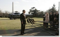 President George W. Bush talks wiith reporters on the South Lawn of the White House, Tuesday, Feb. 21, 2006, supporting the right of a United Arab Emirates business, following a thorough U.S. government review, to purchase the rights to manage six U.S. seaports. President Bush also emphasized that the security of the ports would continue to be managed by the U.S. Coast Guard and U.S. Customs.  White House photo by Kimberlee Hewitt