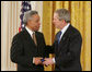 President George W. Bush congratulates Dr. Carl Anderson of Washington, upon receiving the President's Volunteer Service Award during a White House celebration of African American History Month. White House photo by Paul Morse