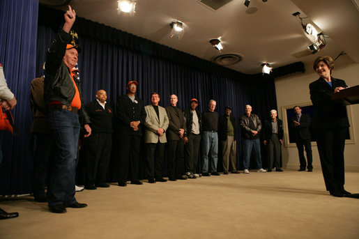 Mrs. Laura Bush introduces Fred Schwake, left, a trainer with the 1966 Texas Western Championship Basketball Team and his fellow teammates, Thursday, Feb. 23, 2006 at the "Glory Road" movie screening event at the Eisenhower Executive Office Building in Washington. The movie chronicles the Texas Western team's first time all-black lineup in the 1966 NCAA playoffs and upsetting the favored University of Kentucky team to win the national title. White House photo by Shealah Craighead