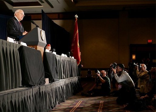 Press photographers steady their cameras as Vice President Dick Cheney delivers remarks to members of the American Legion, a community-service organization made up of nearly three million war-time veterans, during the organization's annual conference in Washington, Tuesday, February 28, 2006. White House photo by David Bohrer